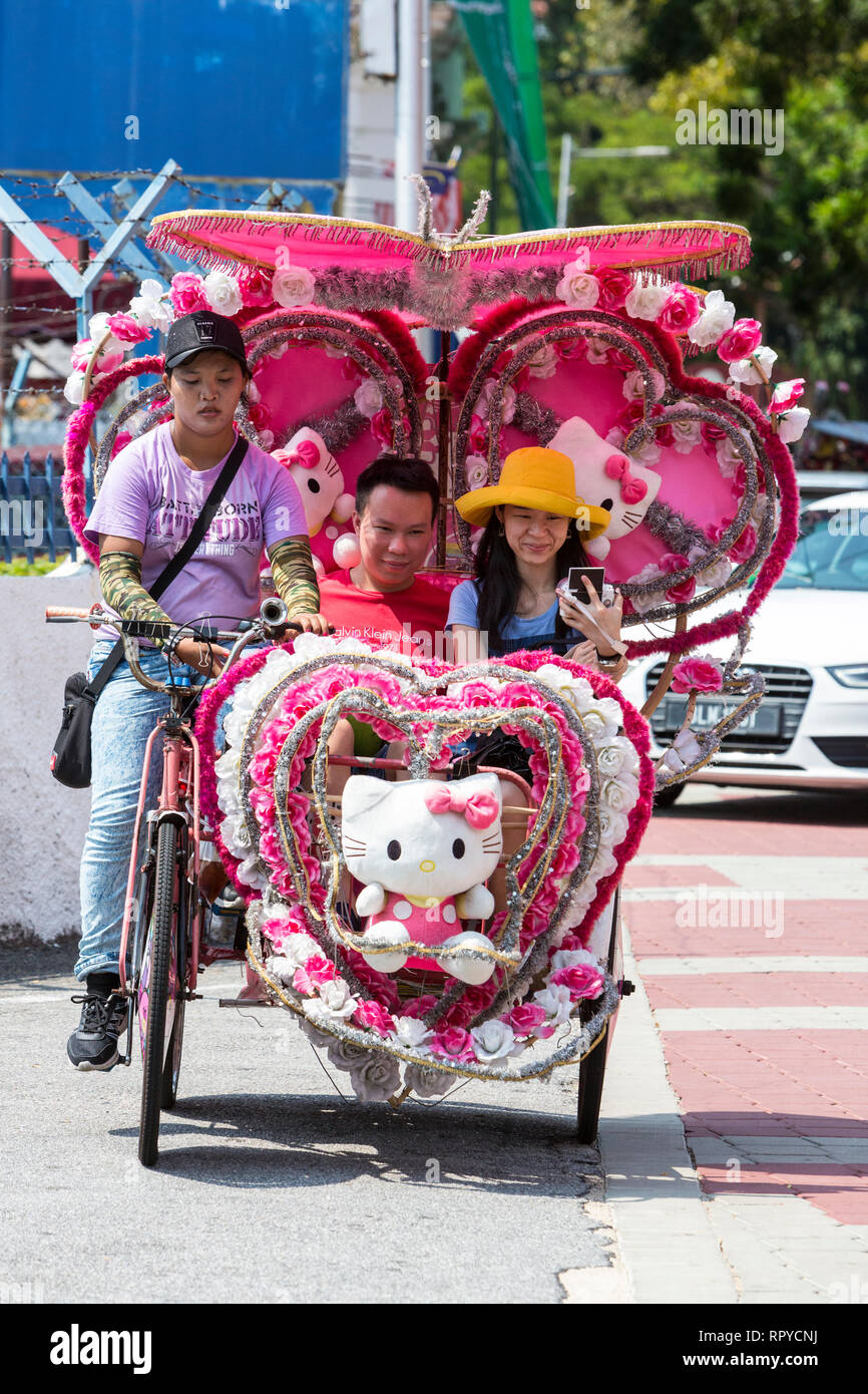 I turisti di equitazione in riscio', Melaka, Malaysia. Foto Stock