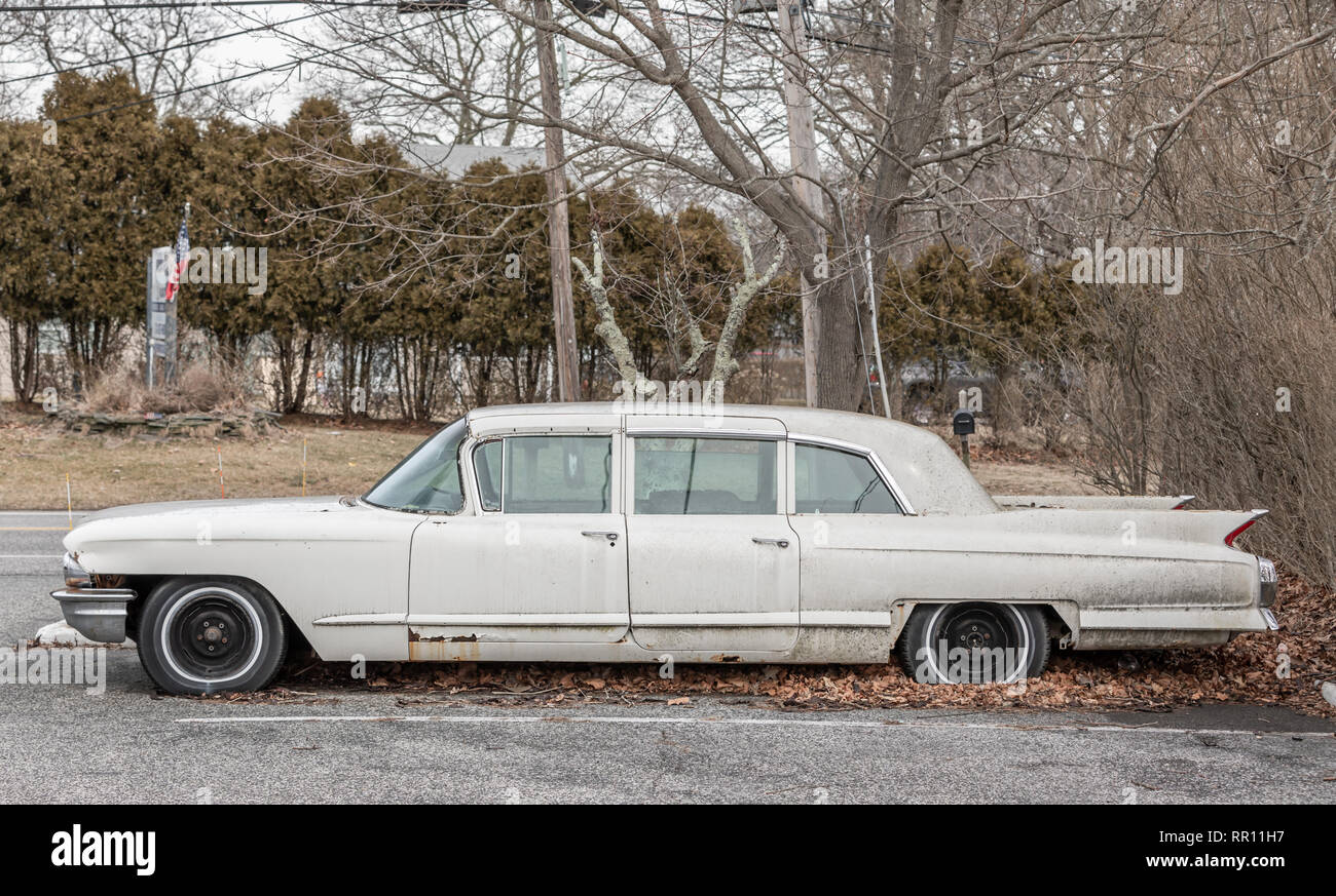Vista laterale di un vecchio abbandonato bianco Cadillac seduto in un parcheggio Foto Stock