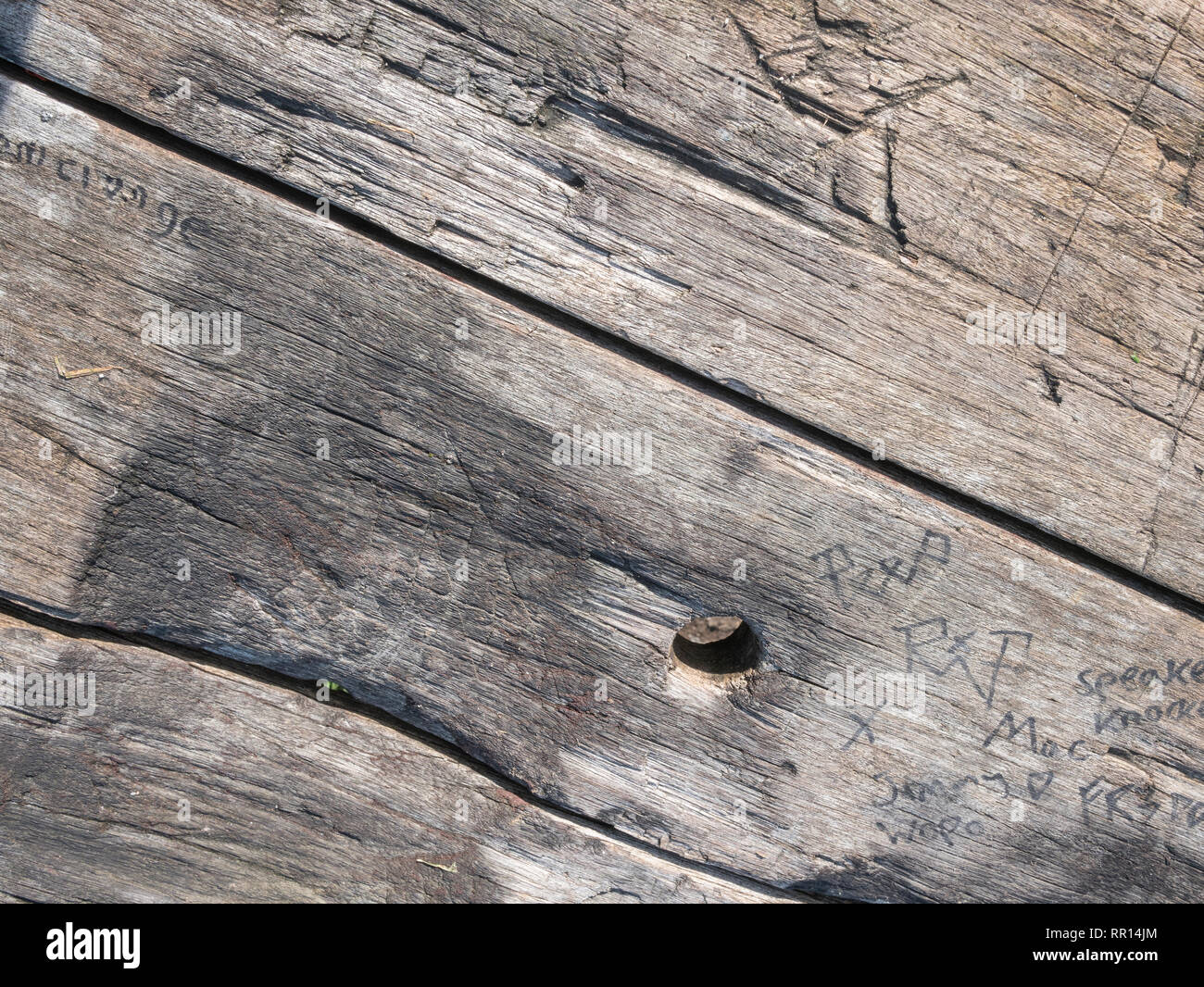 Weathered e nodose esterni in legno tavolo texture in sunshine. Foto Stock