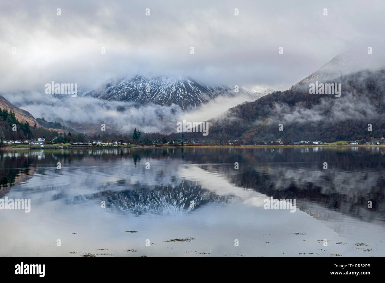 Loch Leven dalla riva nord con ciuffi di nuvola sul loch e cancellare le riflessioni dei dintorni.Glencoe Scozia Scotland Foto Stock
