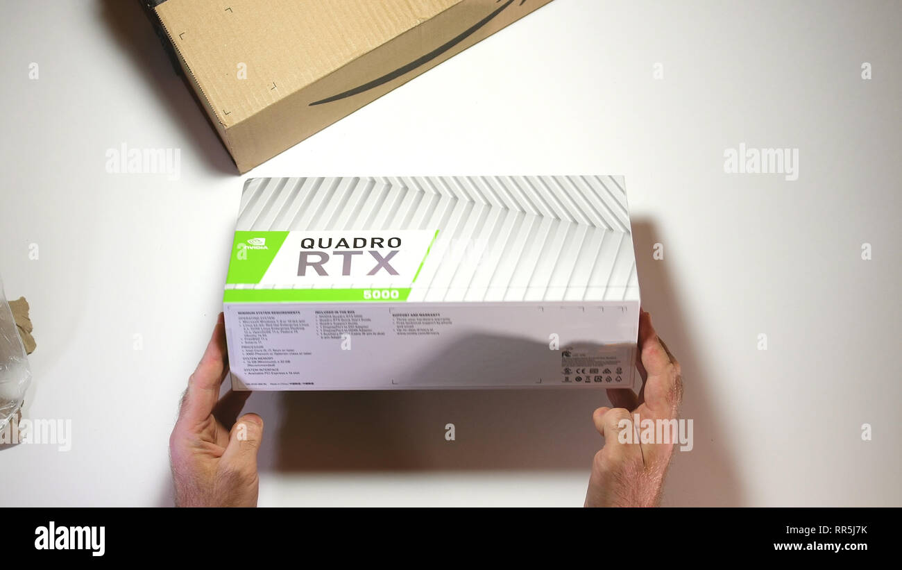 Parigi, Francia - 20 Feb 2019: vista da sopra POV uomo unboxing ultime Nvidia Quadro di RTX 5000 professional workstation scheda video GPU per CGI CAD calcoli scientifici e macchina imparare guardando la scatola Foto Stock
