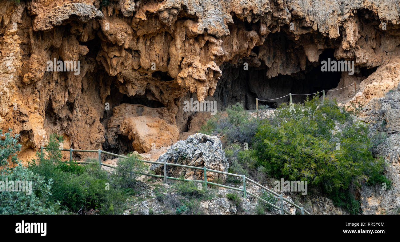 Profonda grotta con staccionata in legno di accesso del percorso Foto Stock