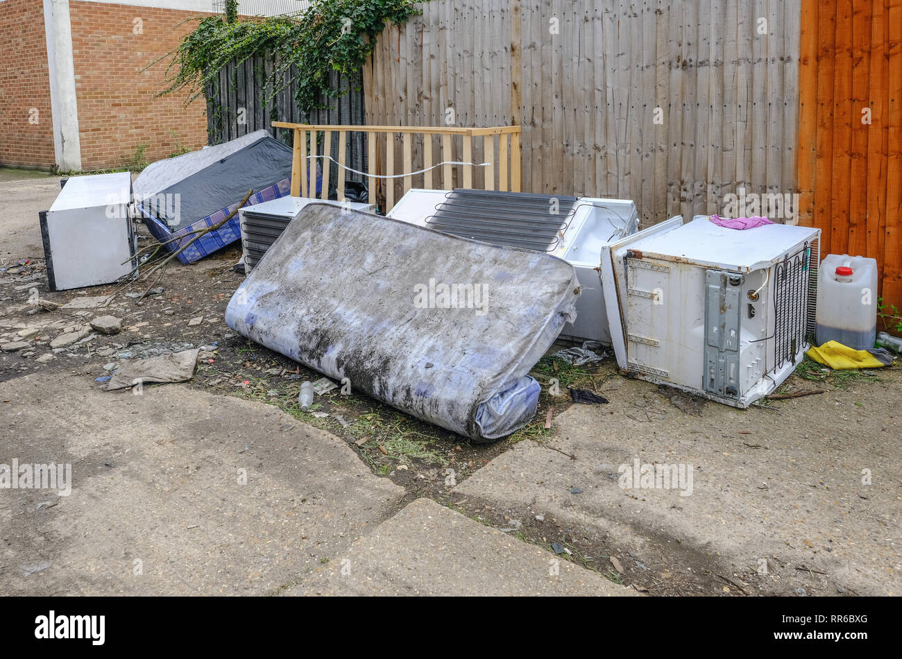 Grande cucina elementi oggetto di dumping in un vicoletto. Frigorifero e freezer e il materasso. Volare il ribaltamento è un anti-sociale di abitudine che è un moderno flagello della nostra società. Foto Stock Grande cucina elementi oggetto di dumping in un vicoletto. Frigorifero e freezer e il materasso. Volare il ribaltamento è un anti-sociale di abitudine che è un moderno flagello della nostra società. Foto Stock