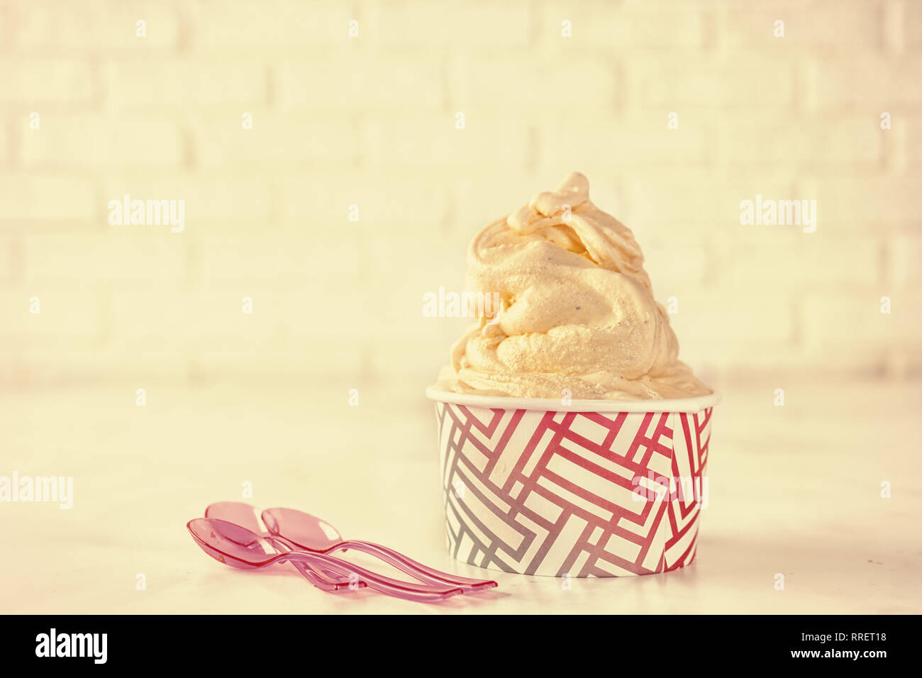 Chiusura del soft ice cream in bicchiere di carta. Retrò shabby tonificante Foto Stock