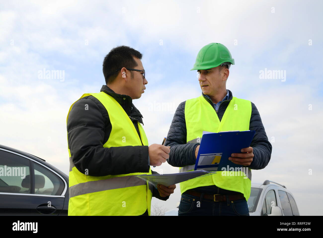 Ingegnere mostrando qualcosa sulla carta al loro capo su recentemente costruita autostrada Foto Stock