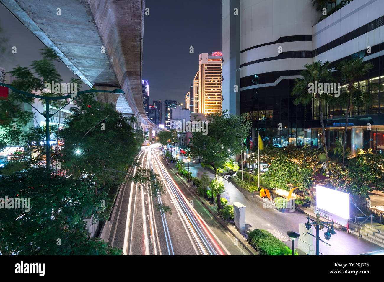 Vista di elevazione via dello skytrain e traffico sentieri di luce sulla Strada di Sukhumvit Road nel centro cittadino di Bangkok, Thailandia, Sud-est asiatico, in Asia Foto Stock
