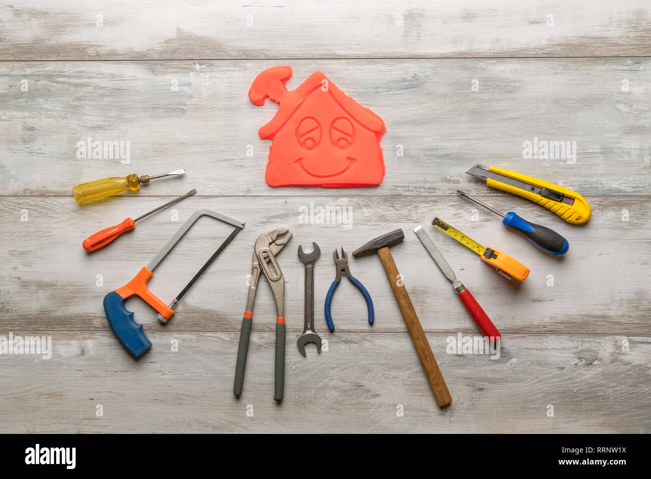 Gruppo di utensile di lavoro su rustiche in legno con sfondo icona della casa in spazio, industria strumento tecnico di concetto. Foto Stock