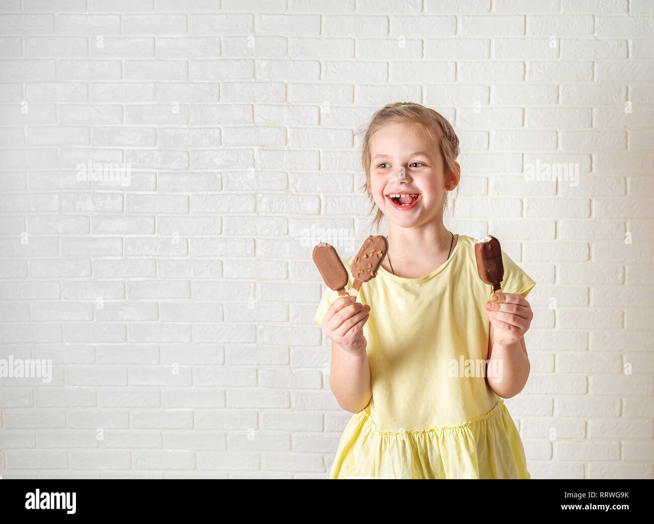 Felice bambina mangiare ghiaccioli al tempo estivo, spazio di copia Foto Stock