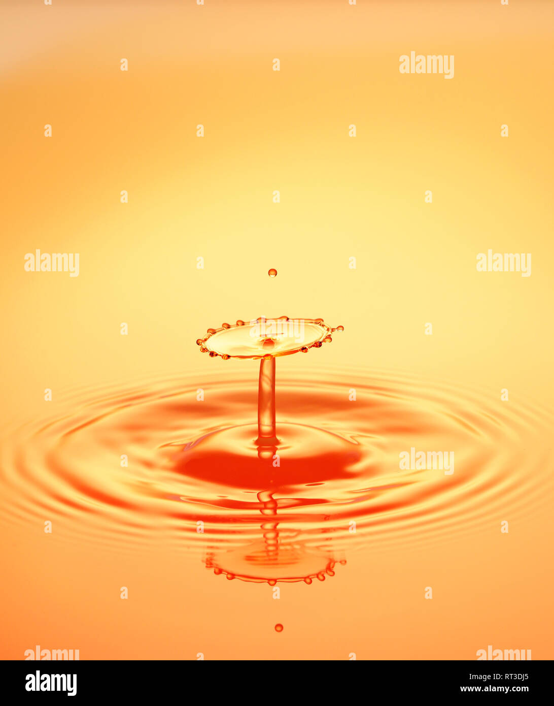 Collisione di gocce di acqua che forma una bella struttura. Illuminata con colori forti. Foto Stock