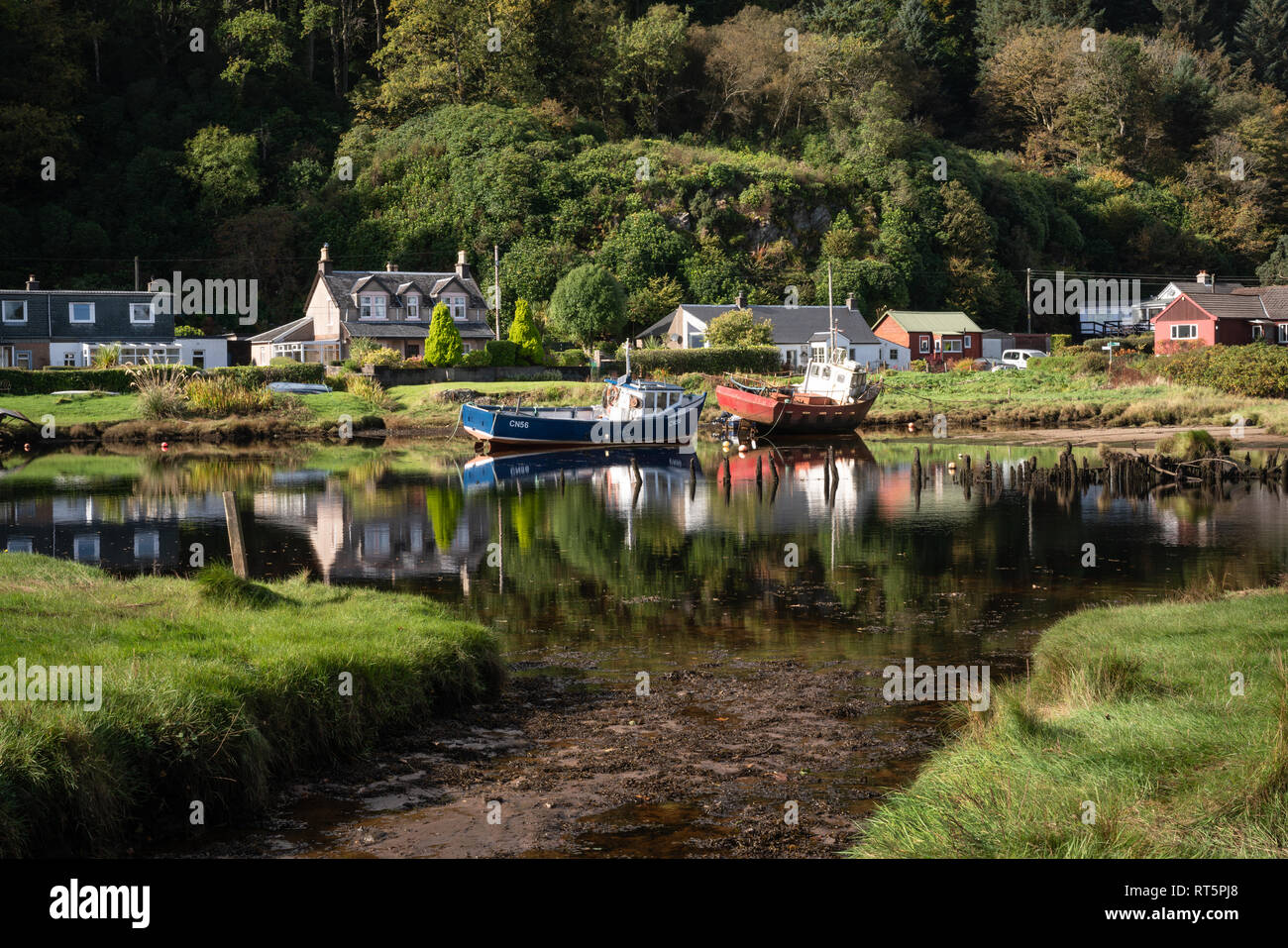 Barche da pesca ormeggiate nella parte anteriore del case di Waterfoot vicino al villaggio di Carradale sulla penisola di Kintyre in un pomeriggio soleggiato. Foto Stock