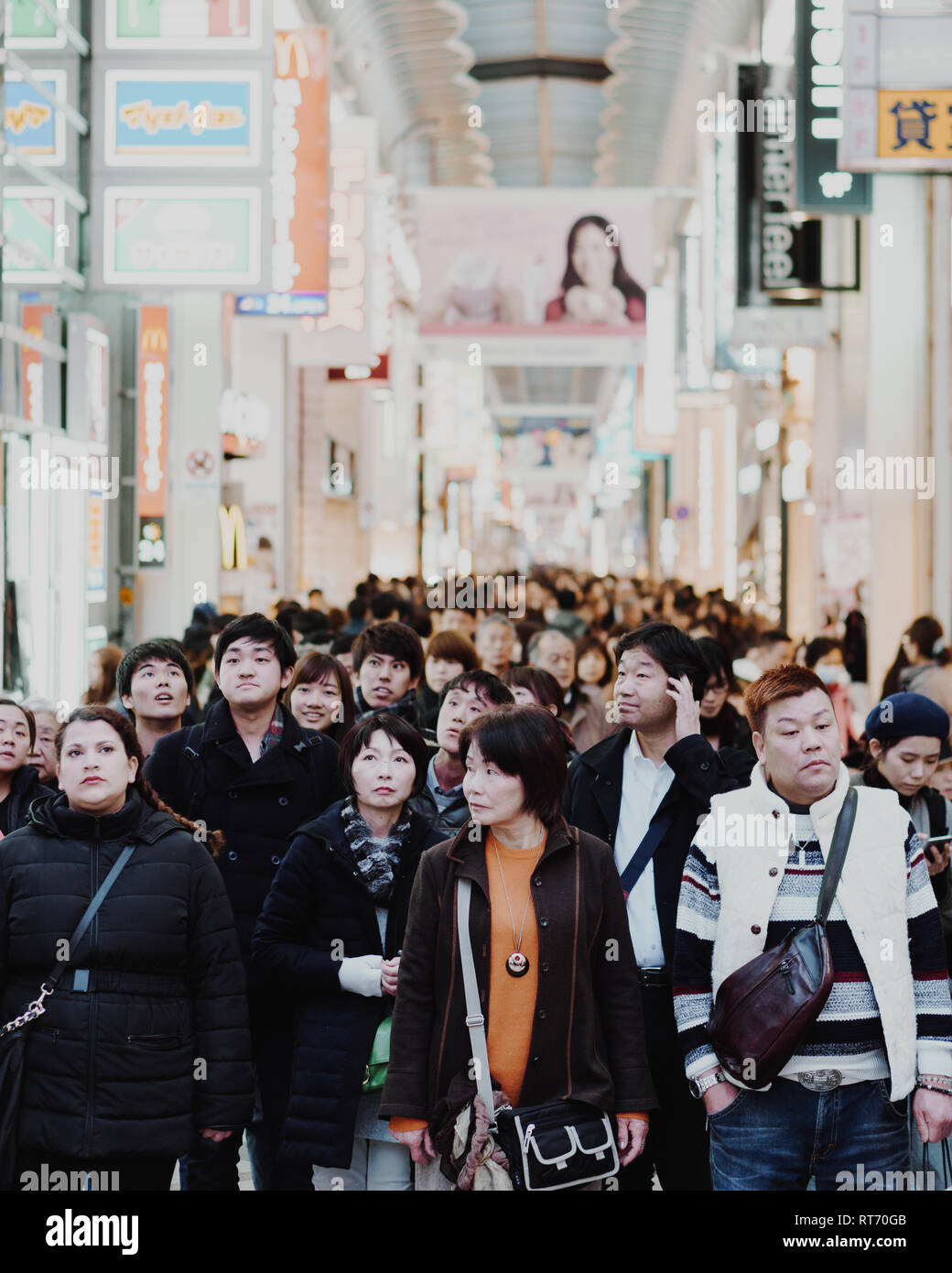 Folla enorme di persone tutti guardando cose diverse in attesa ad un incrocio nel Dotonbori, Osaka. Foto Stock