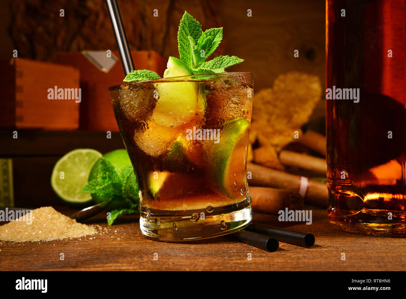 Cuba Libre Cocktail con i sigari su sfondo di legno Foto Stock