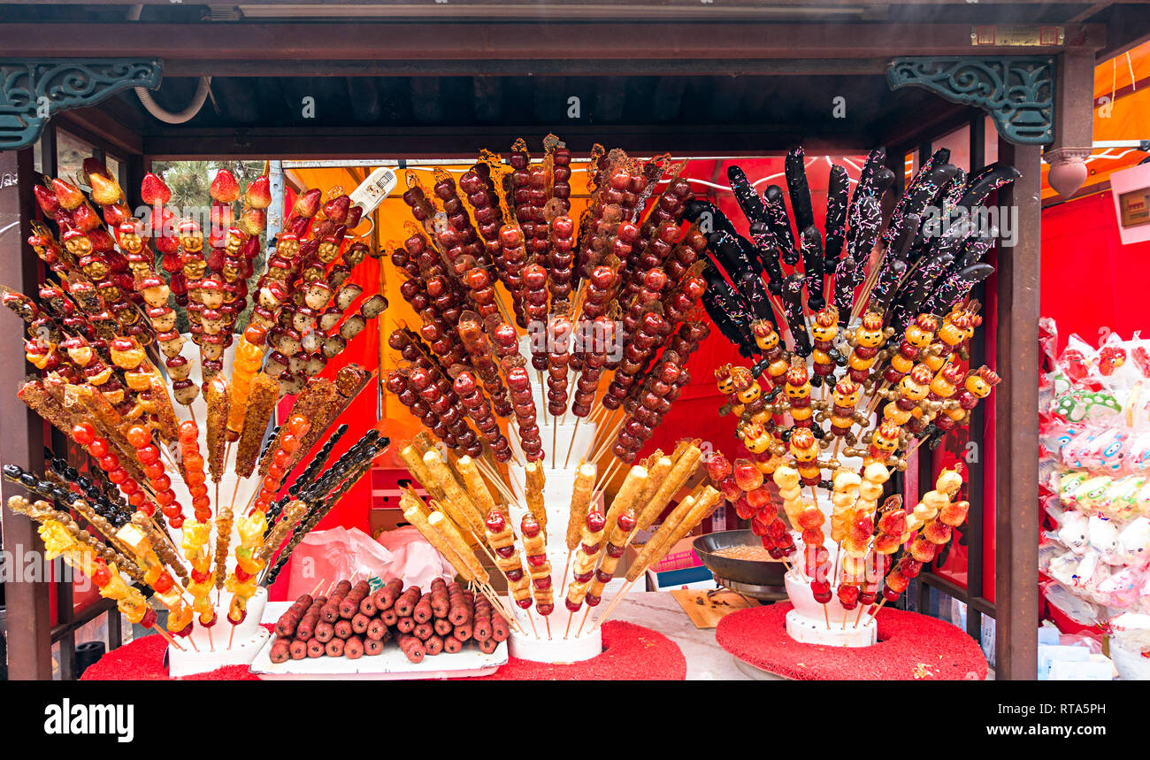 Il Cinese tradizionale cibo locale: rivestite di zucchero haws su una stick su cabina Foto Stock Il Cinese tradizionale cibo locale: rivestite di zucchero haws su una stick su cabina Foto Stock