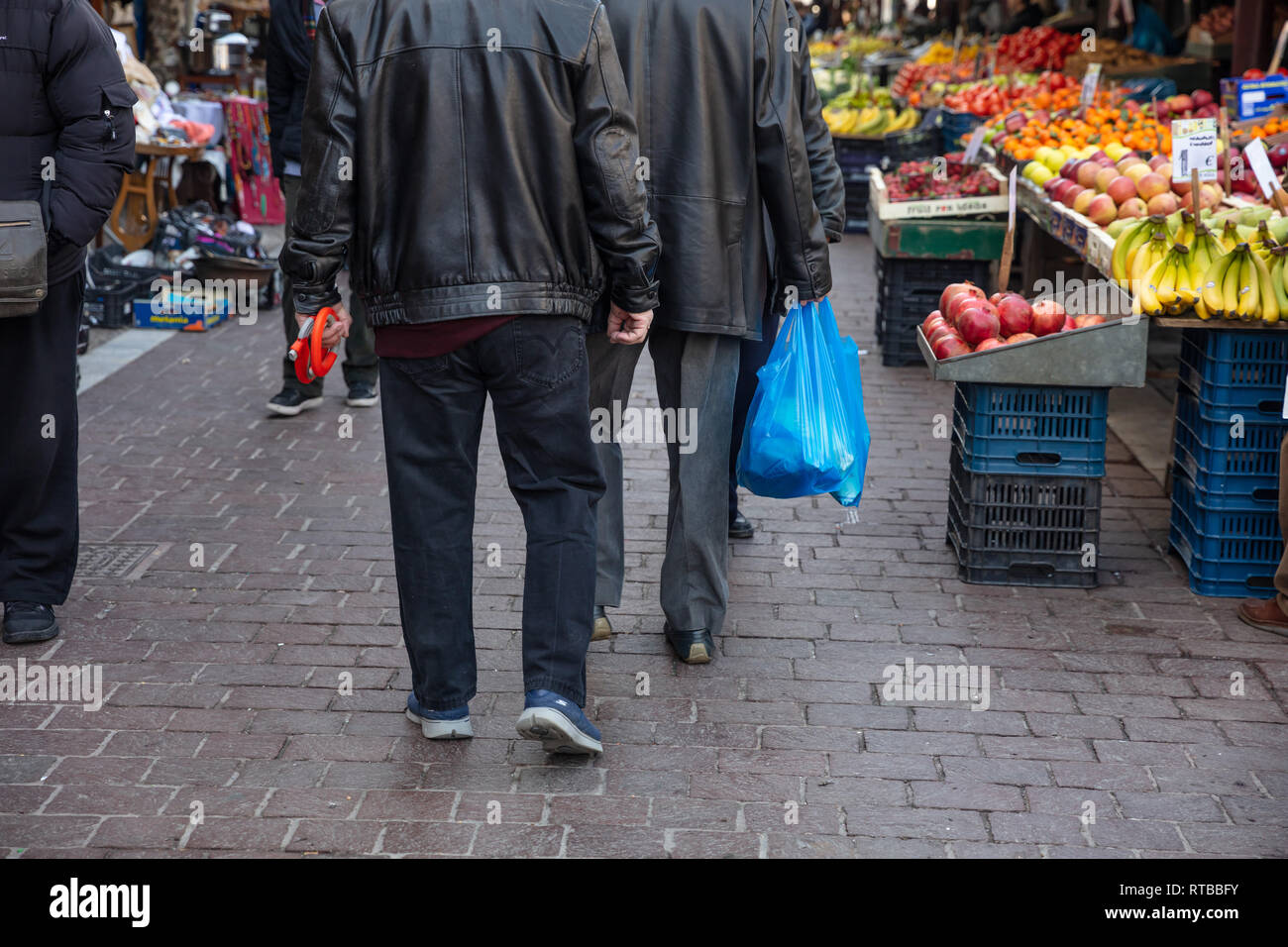 Febbraio 19, 2019. Atene Grecia, uomo blu hoding sacchetti di plastica. Primo piano Foto Stock