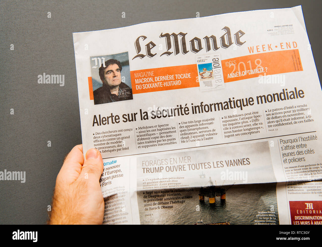 Parigi, Francia - Jan 8, 2018: uomo tenendo Le Monde giornale con Alert su tutto il mondo dell'informatica industria IT dopo più di phishing e attacchi di virus Foto Stock
