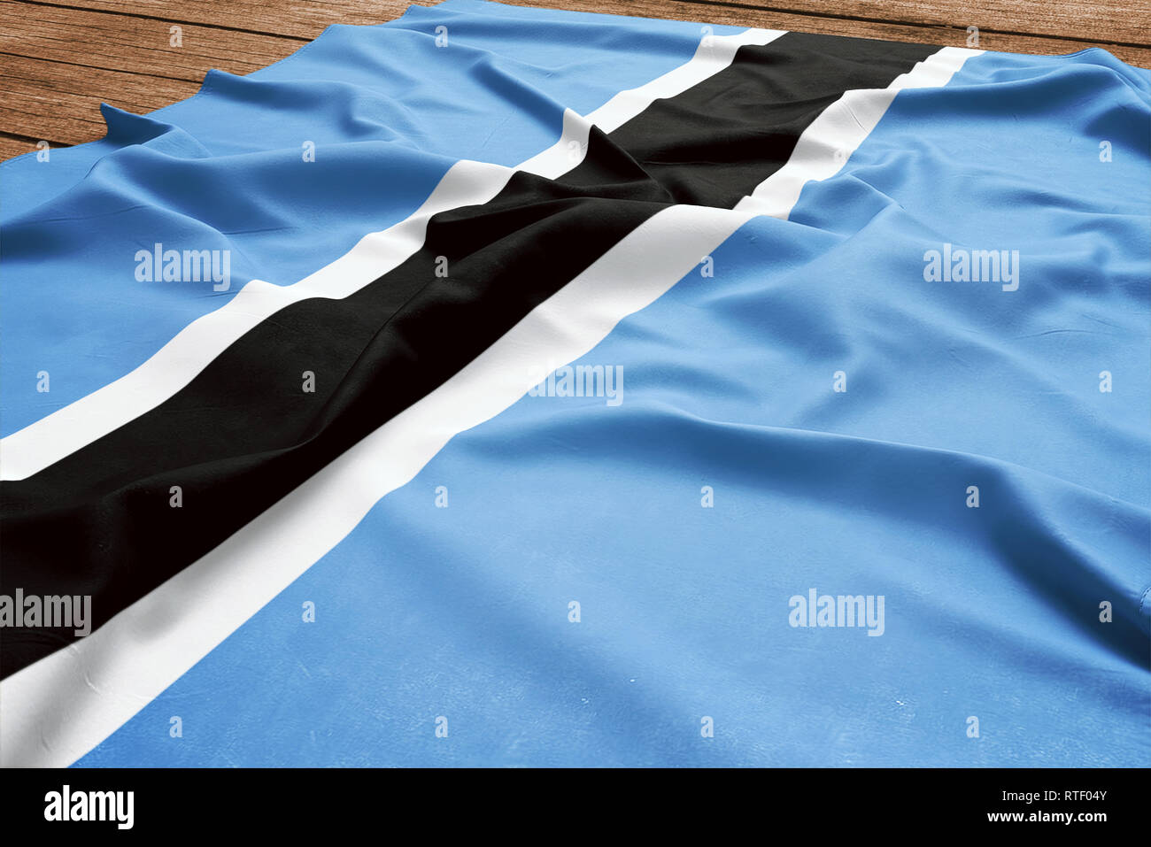 Bandiera del Botswana su una scrivania in legno sfondo. Seta flag Motswana vista dall'alto. Foto Stock