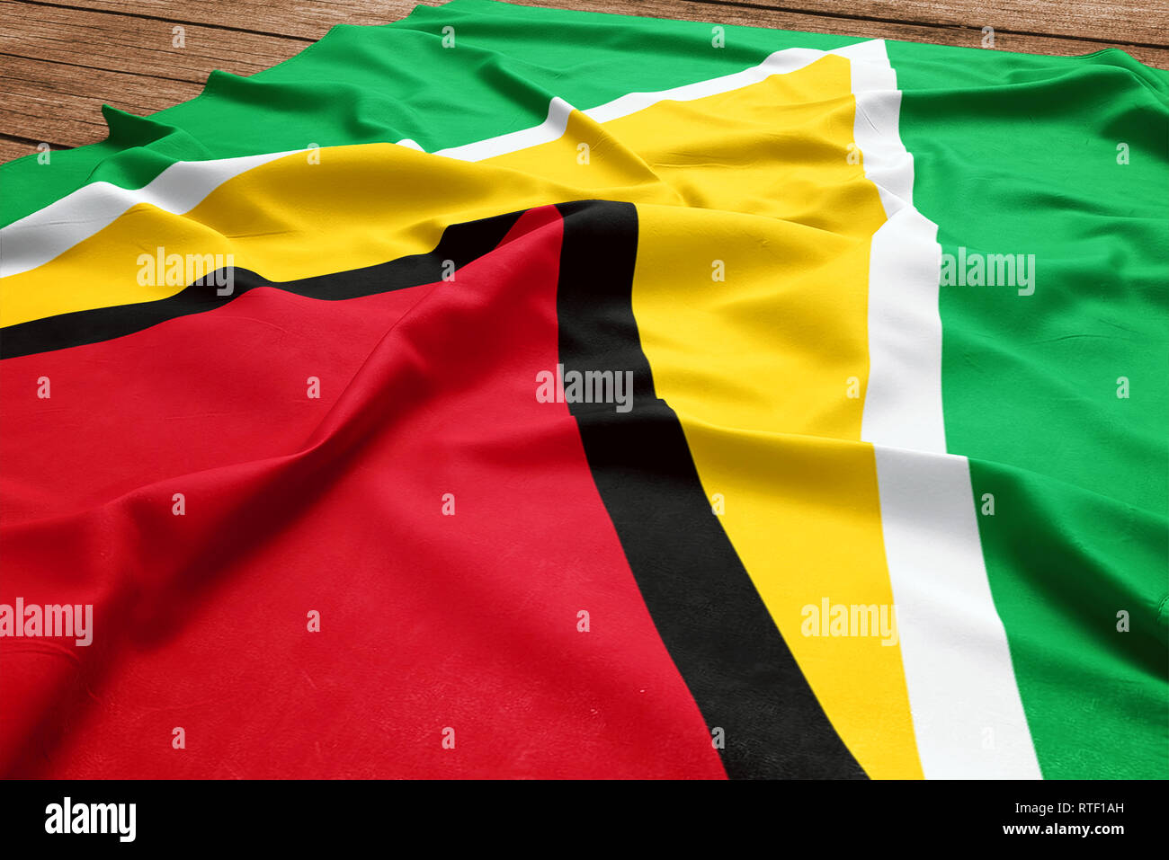 Bandiera della Guyana su una scrivania in legno sfondo. Seta flag Guyanese vista dall'alto. Foto Stock