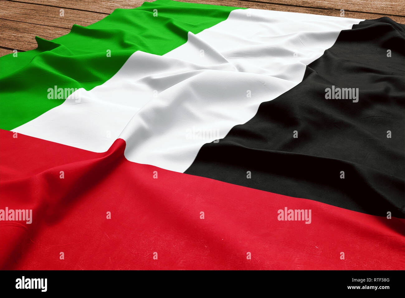 Bandiera degli Emirati Arabi Uniti su una scrivania in legno sfondo. Seta flag Emirian vista dall'alto. Foto Stock