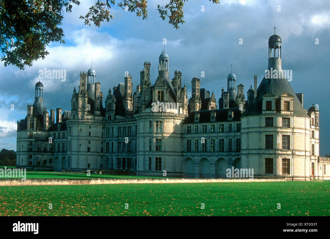 La suggestiva architettura dello Chateau Royal de Chambord si erge maestosamente contro un cielo limpido, circondato da lussureggianti giardini. Loir et Cher. Francia Foto Stock