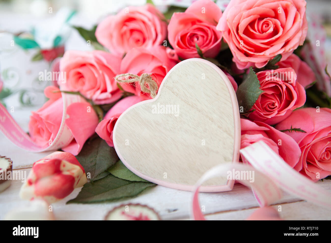 Mazzetto di lussureggianti e le rose rosa e un cuore con spazio di copia Foto Stock