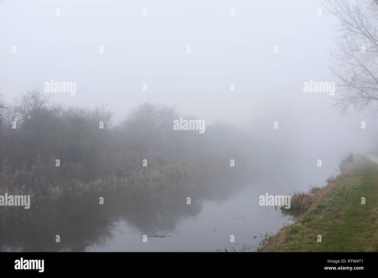 Inverno 2019, fisherman pesca nel early morning mist, Grantham a Nottingham canal. Hickling, Melton Mowbray, Regno Unito Foto Stock