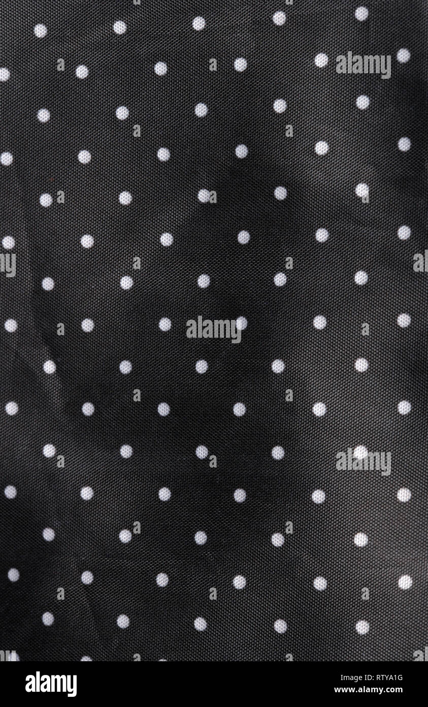 Tessuto nero lo sfondo con puntini bianchi Foto Stock
