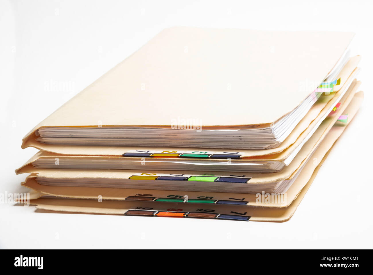 Una pila di paziente medical records in cartelle con colori codificati e schede numerate. Foto Stock