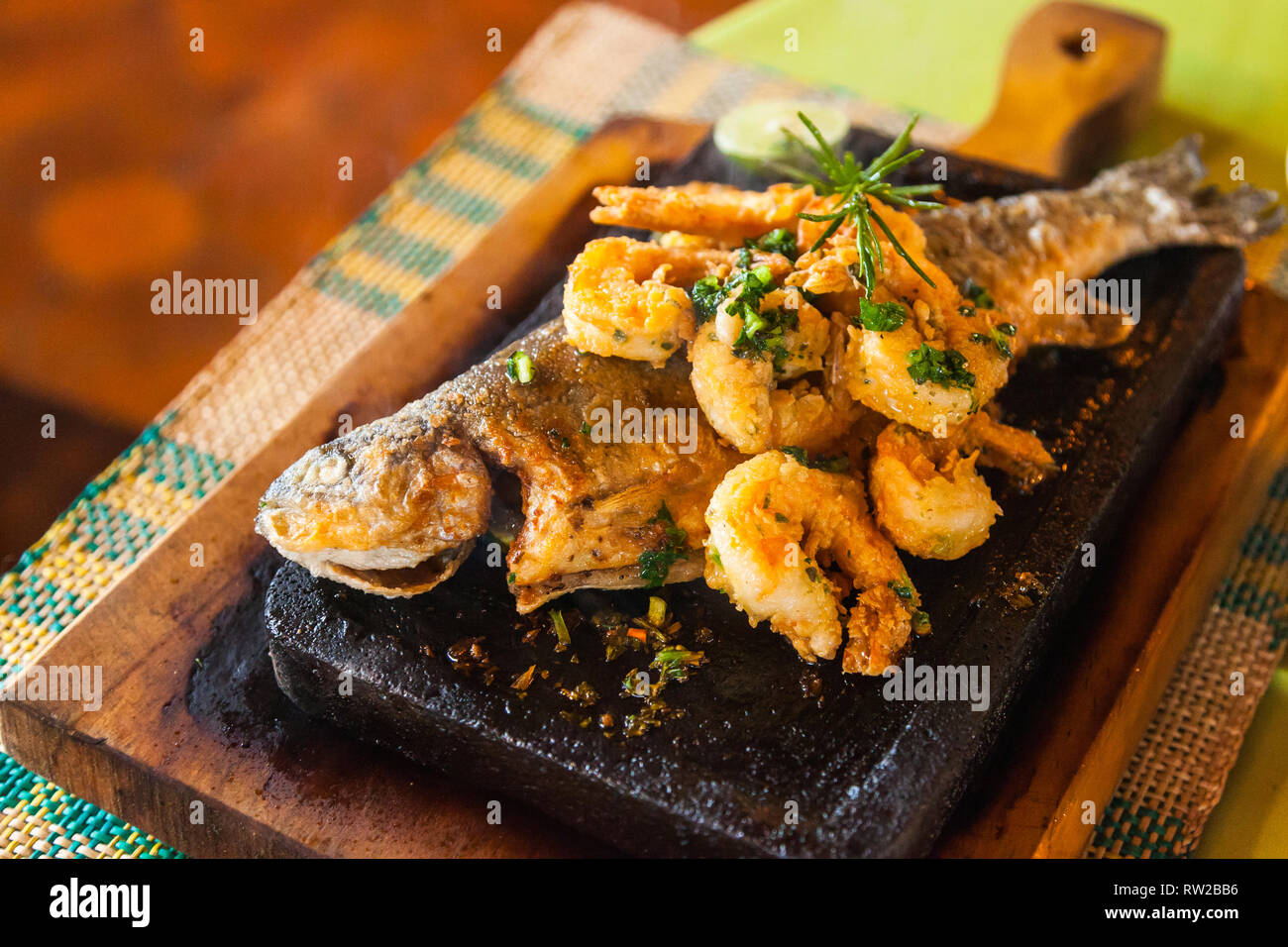 Trote sulla pietra; tutta la trota, servita sulla pietra calda con gamberetti Foto Stock