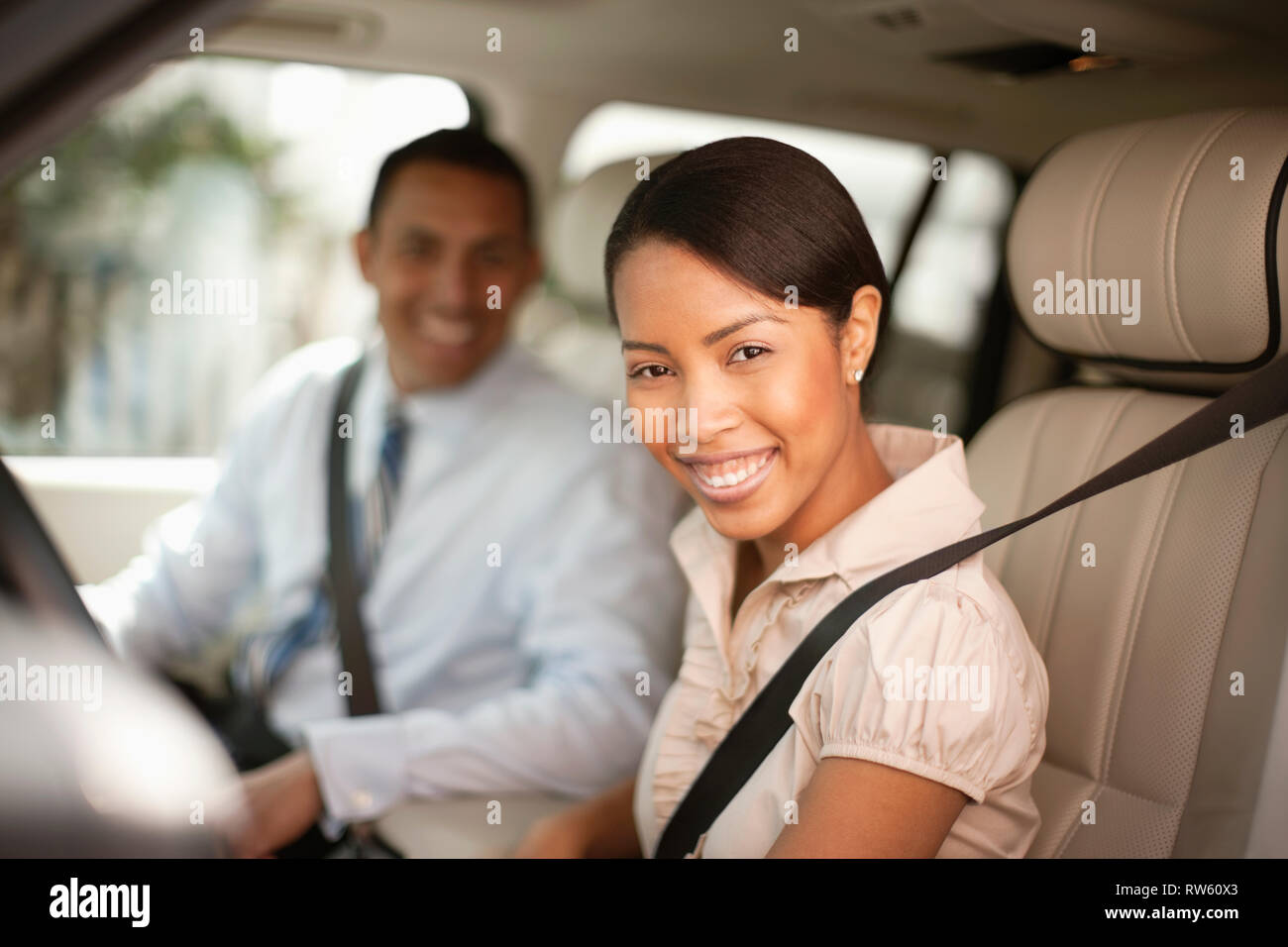 L uomo e la donna seduta in auto sorridente verso la telecamera Foto Stock
