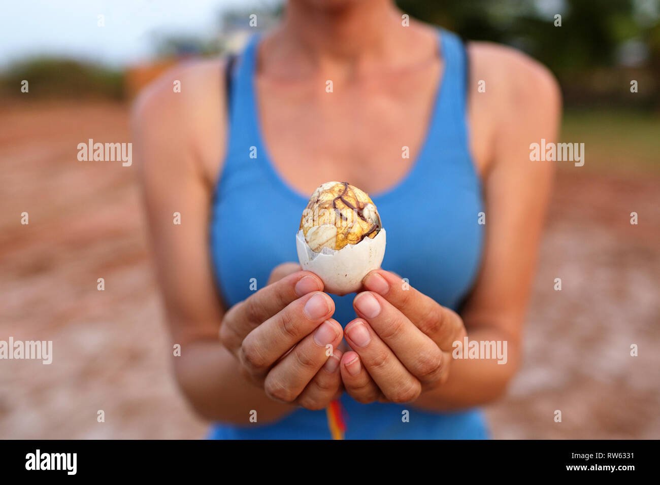 Donna che mantiene l'Anatra fetale Balut uova in guscio, Kampot, Cambogia Foto Stock