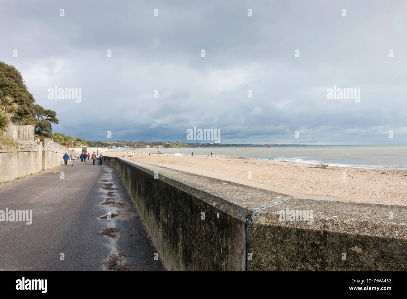 La gente fuori e circa una domenica pomeriggio, passeggiate lungo la spiaggia di Avon, Mudeford, Dorset, Regno Unito Foto Stock