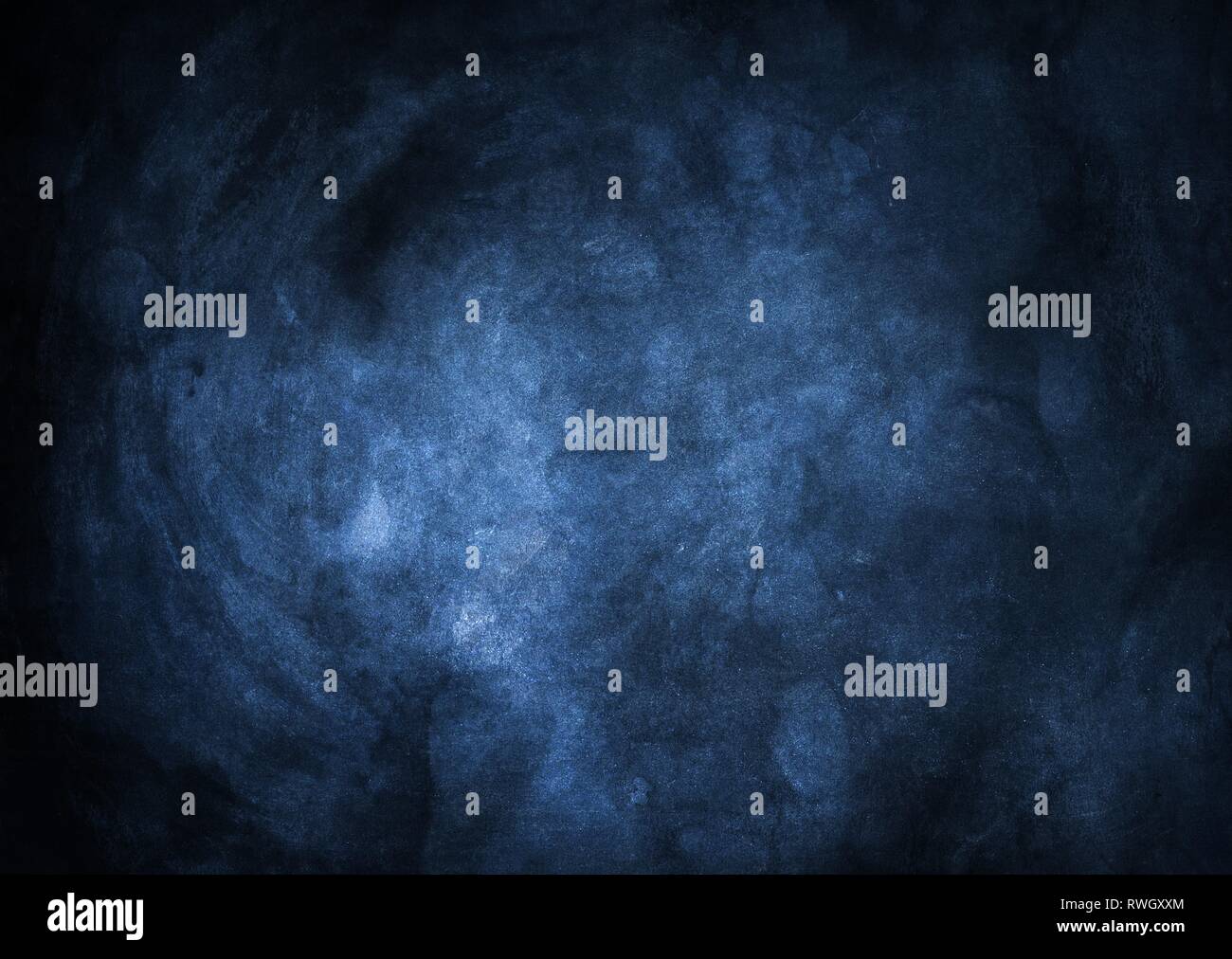 Blu scuro vignettato grunge sfondo con elementi incandescente al centro. Foto Stock