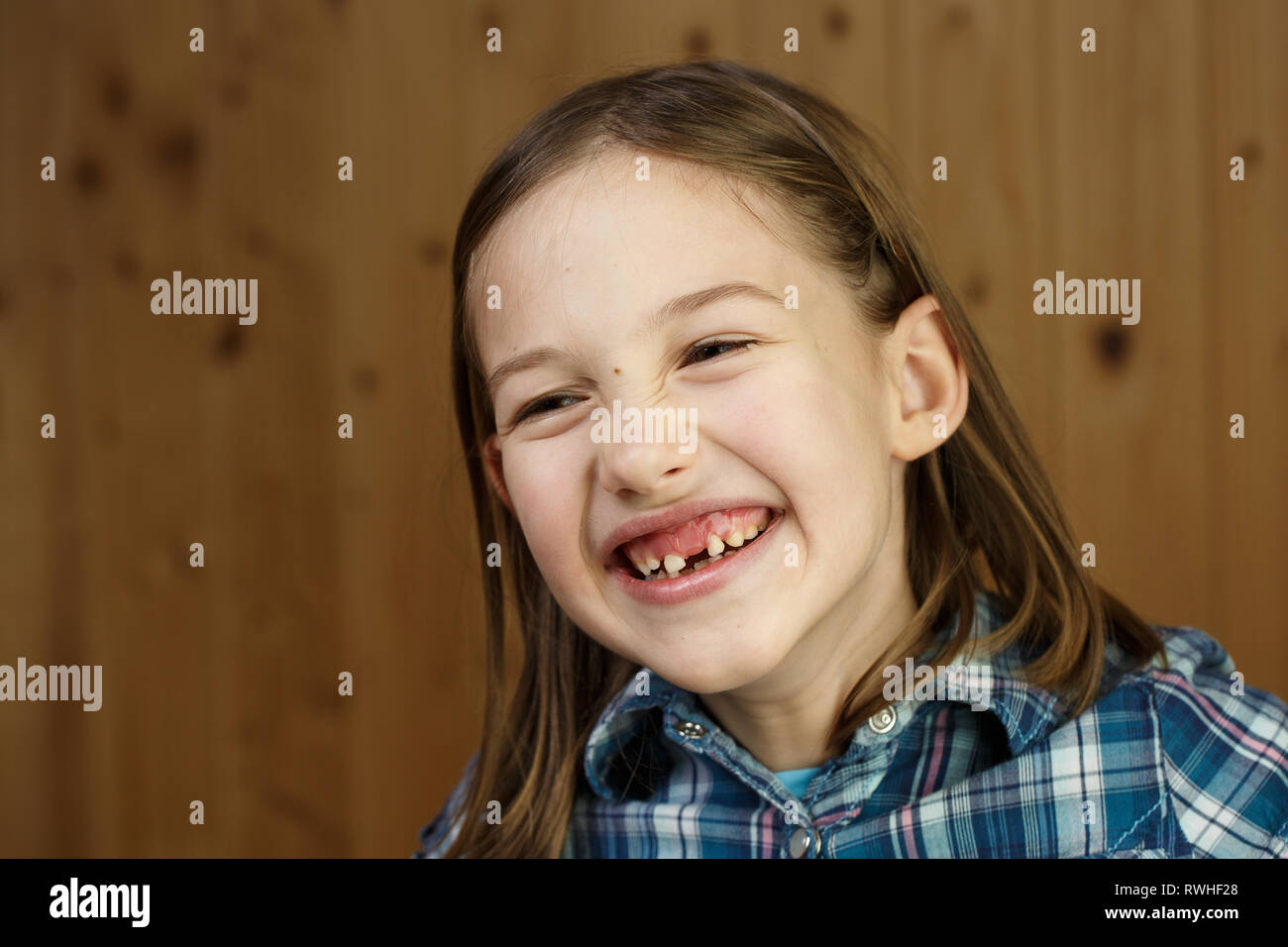 Piccola ragazza sorridente, mostrando il suo allentato e mancano i denti di latte. Giocoso e allegro infanzia, dente fata, la crescita e la pietra miliare del concetto. Foto Stock