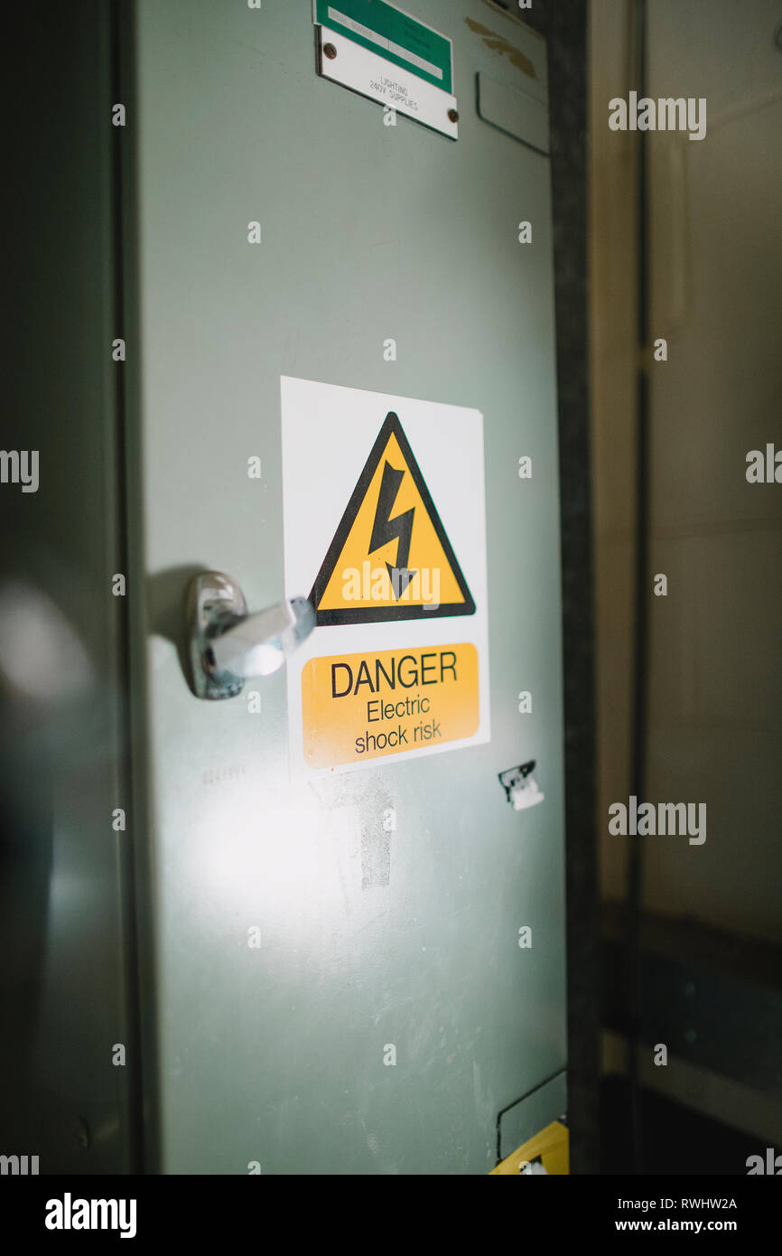 Immagine ravvicinata di un recinto elettrico casella con un segno di avvertimento. Foto Stock