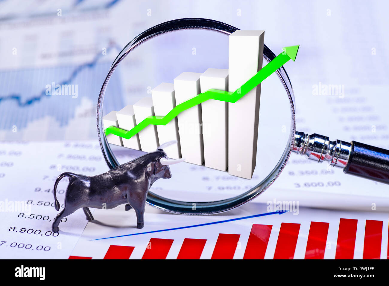 Bull con tabelle, grafici e una lente di ingrandimento Foto Stock