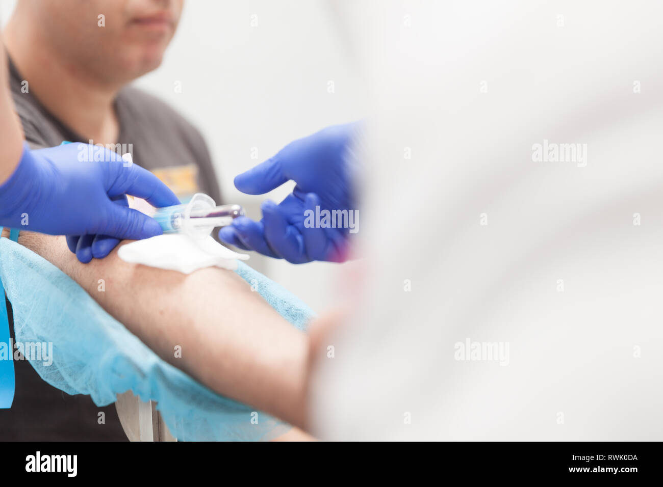 Medico di laboratorio estrarre sangue da un paziente Foto Stock