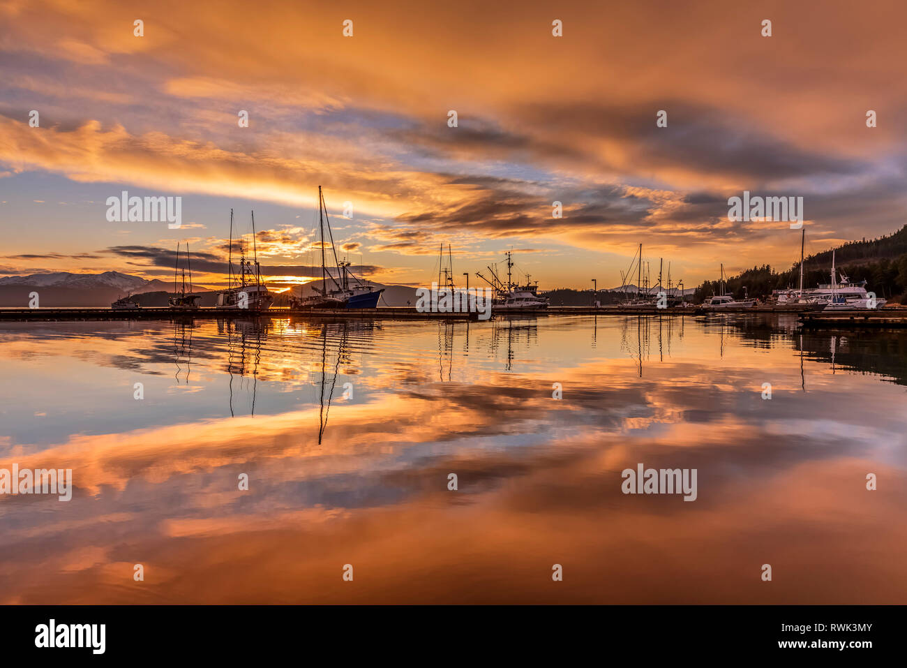 Commerciale barche da pesca in Auke Bay al tramonto, Alaska sudorientale; Juneau, Alaska, Stati Uniti d'America Foto Stock