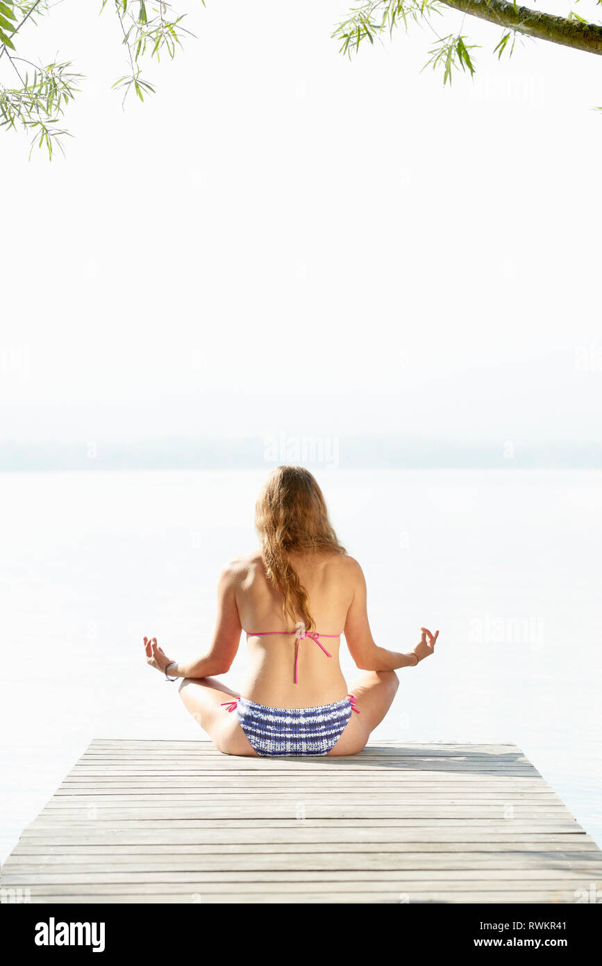 Donna fare yoga da Lac d'Annecy, Annecy, Francia Foto Stock