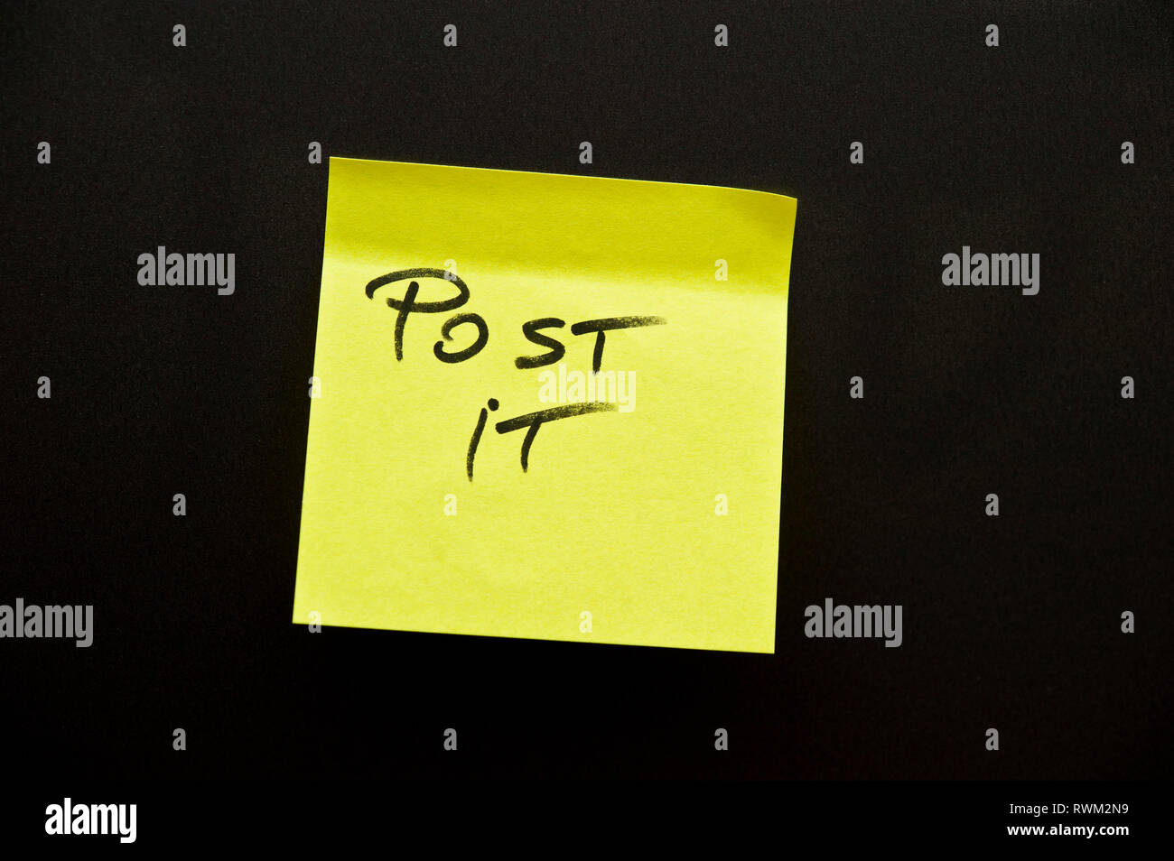 Post-it giallo nota con word POST IT scarabocchiati su di esso Foto Stock