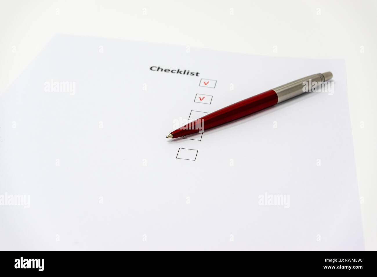Lista di controllo semplice con una penna rossa. Foto Stock