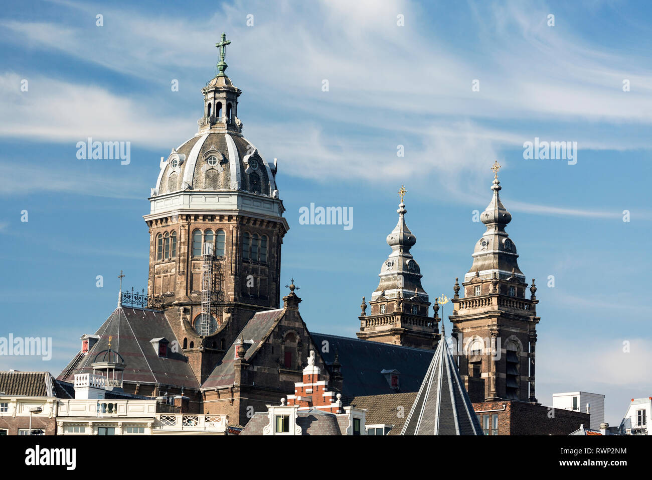 Grande torre a cupola della Basilica di San Nicola con due ulteriori torri cielo blu e nuvole; Amsterdam, Paesi Bassi Foto Stock