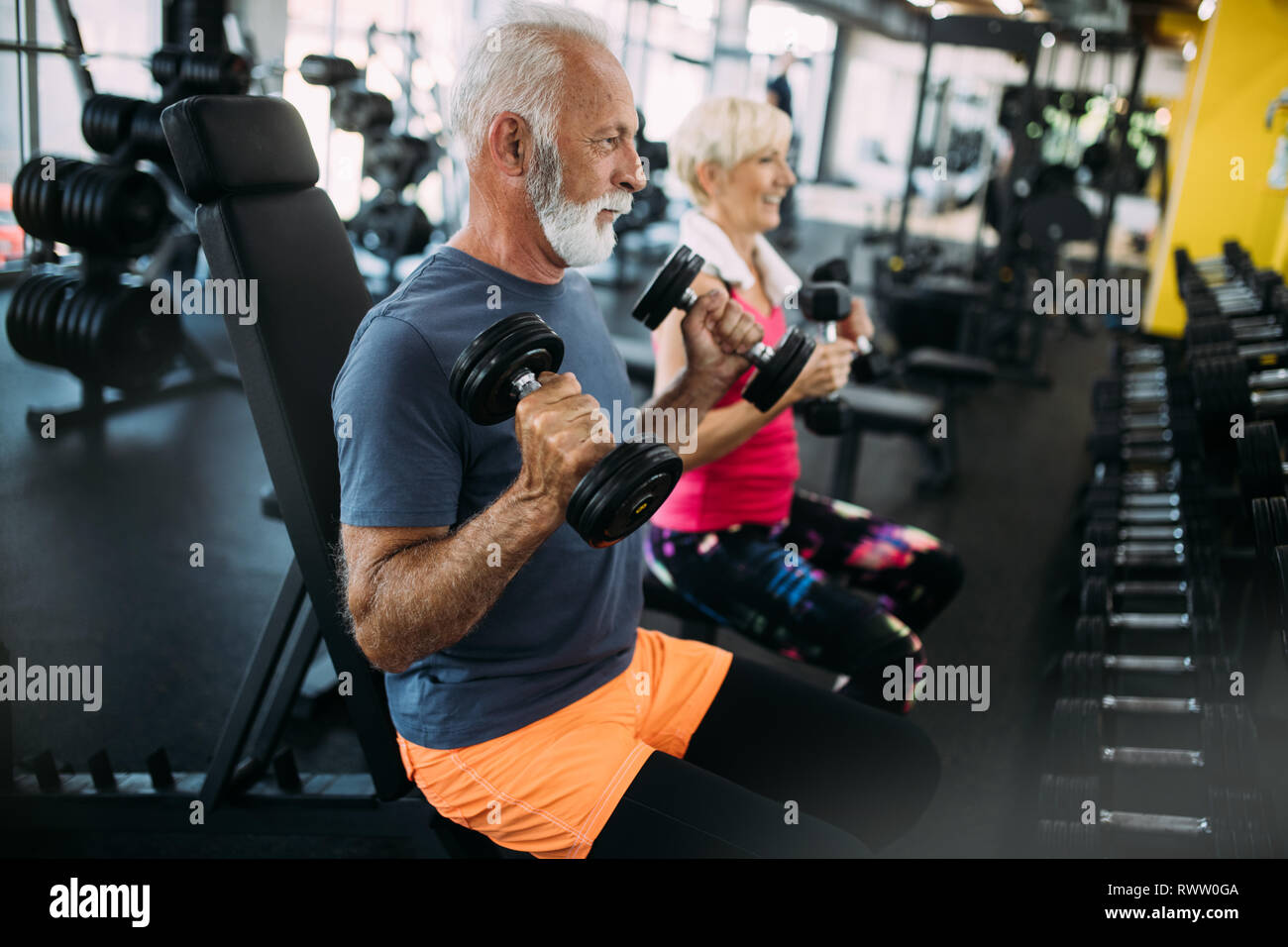 Senior felici le persone a fare gli esercizi in palestra per mantenersi in forma Foto Stock