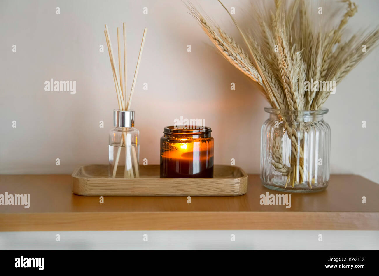 Home decor. Arredamento scaffale con candela, diffusore di aroma e di  spighe di grano in un vaso, lifestyle interior decor dettagli Foto stock -  Alamy