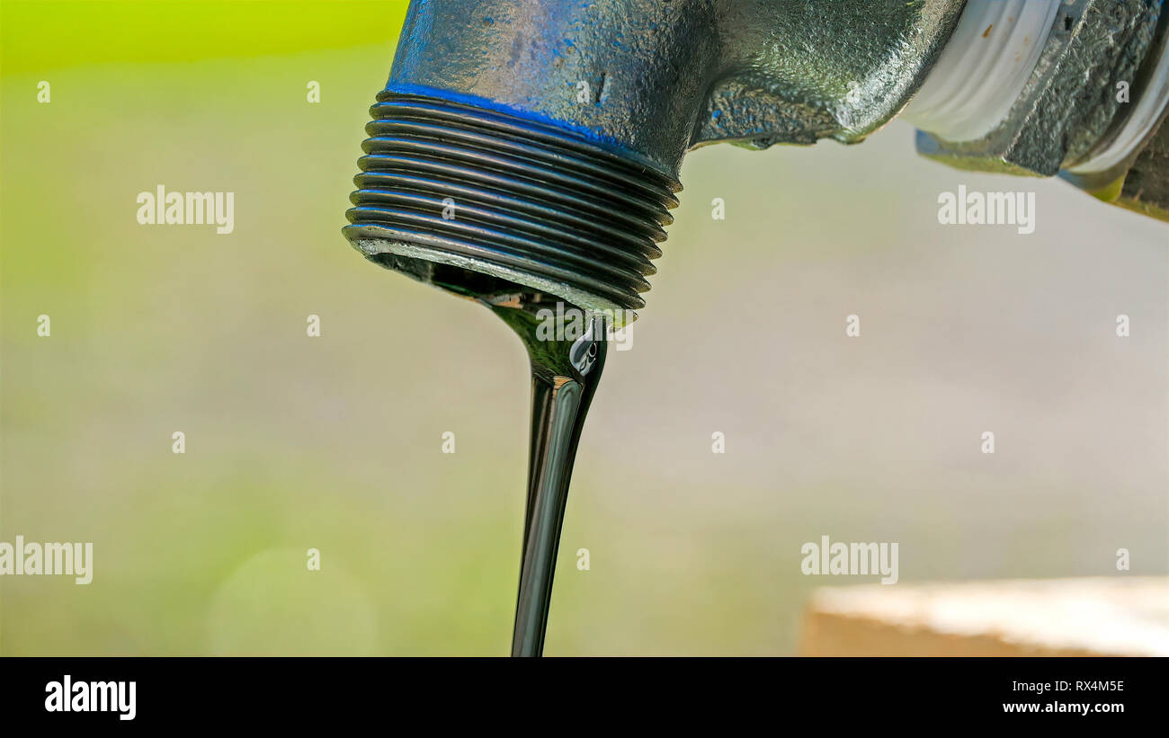 Il nero fluido che fuoriesce dal rubinetto. È interno al tubo del rubinetto Foto Stock