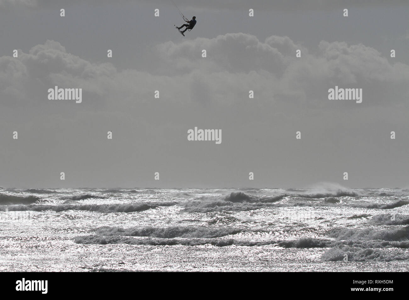 West Strand, West Wittering, Sussex, Regno Unito. Il 10 marzo 2019. Severe gales lungo la costa sud di oggi con raffiche di oltre 60 km/h. Quattro volte campione britannico Kitesurfer Lewis Crathern, famosa per il suo salto kitesurfer oltre il molo di Brighton, in azione a 2XS sport acquatici a West Wittering beach in West Sussex. Credito: James jagger/Alamy Live News Foto Stock