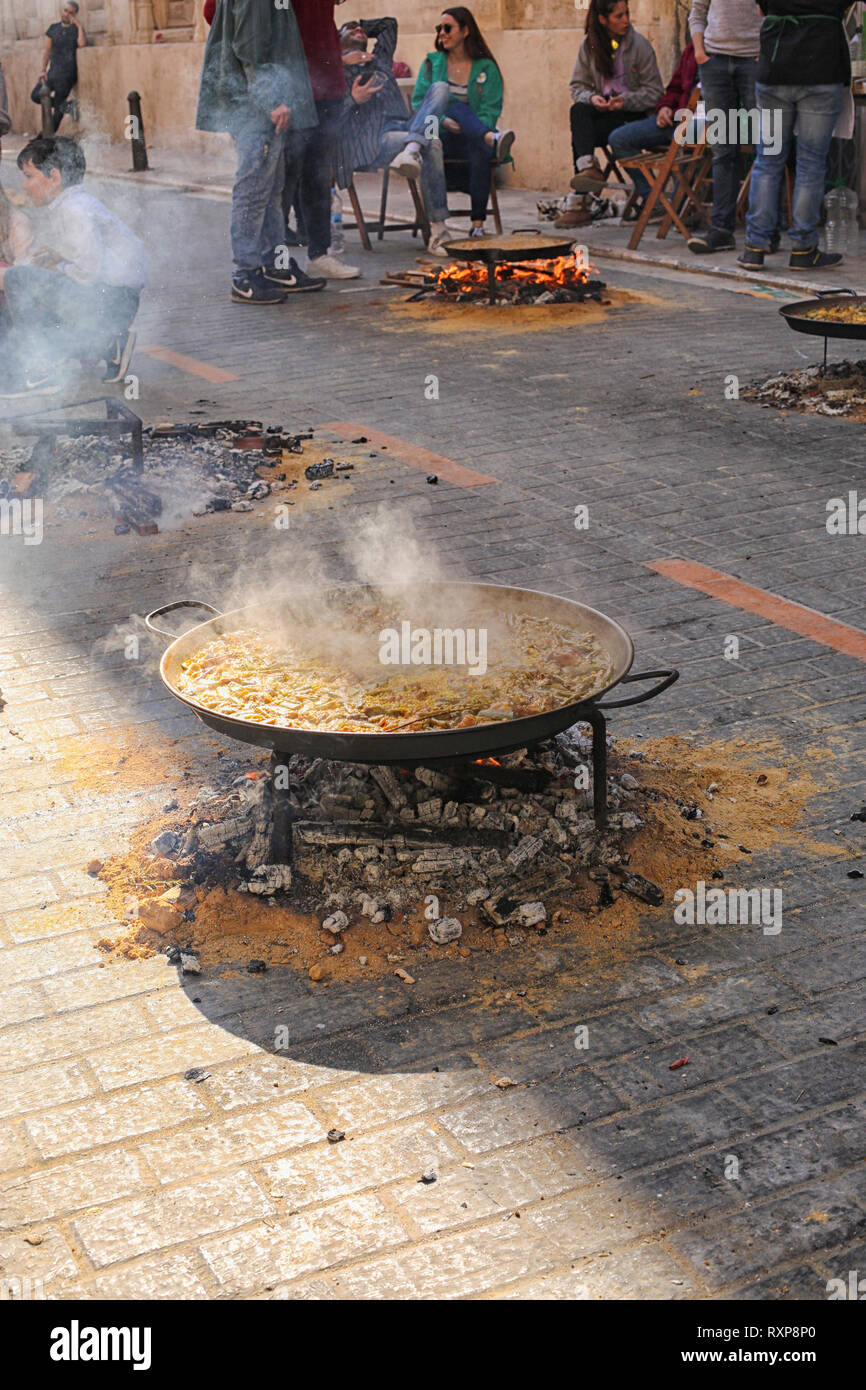 Persone paella di cottura sulla strada a Valencia durante il Fallas Festival, Valencia, Spagna Foto Stock