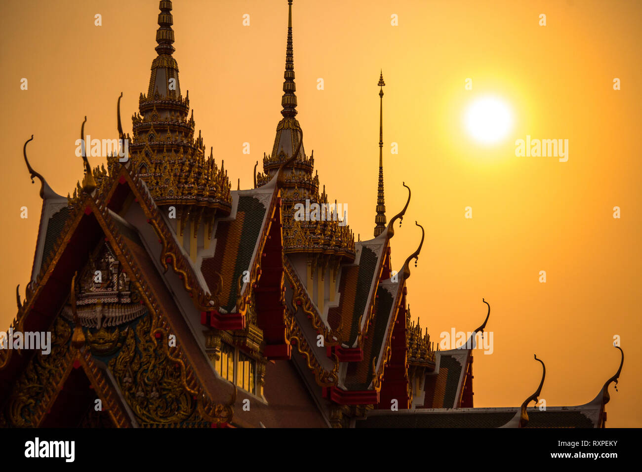 Tempio in Thailandia con il tramonto del sole Foto Stock