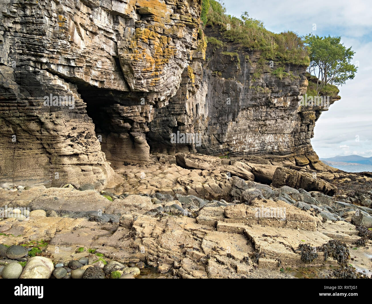 Erose rocce sedimentarie di arenaria del Giurassico scogliere marine e grotte marine sulla costa vicino a Elgol, sull'isola scozzese di Skye, Scozia, Regno Unito Foto Stock