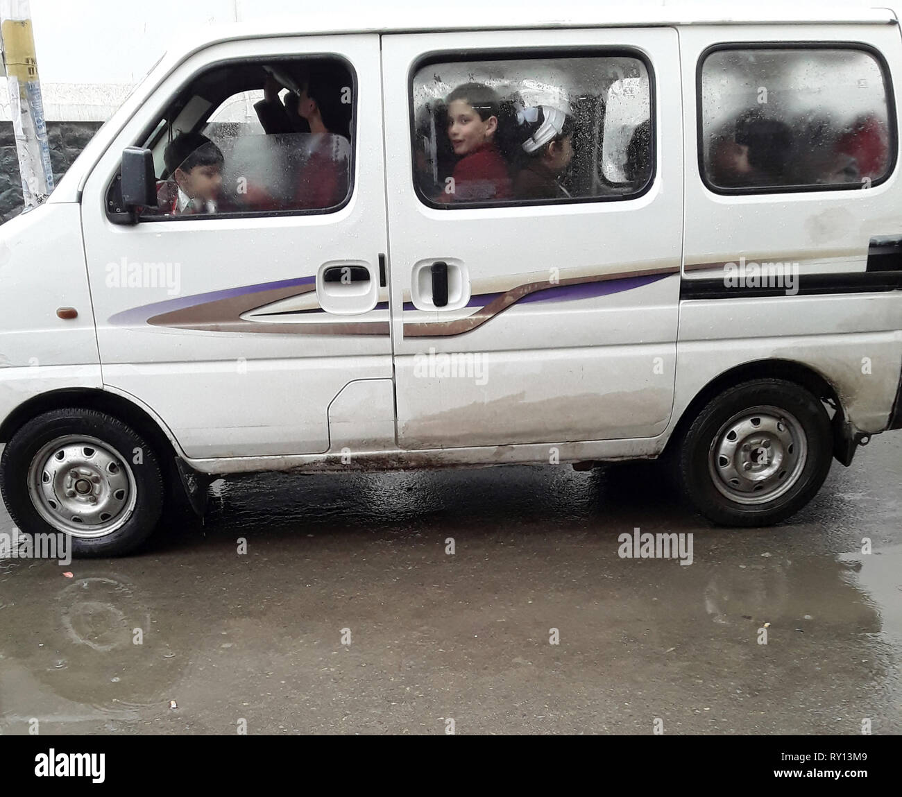Srinagar Kashmir. 11 mar 2019. Scuola del Kashmir bambini peer fuori da una scuola elementare Van come piove.Le scuole nel Kashmir indiano ha riaperto lunedì dopo tre mesi di pausa invernale. Credito: Sofi Suhail/Alamy Live News Foto Stock