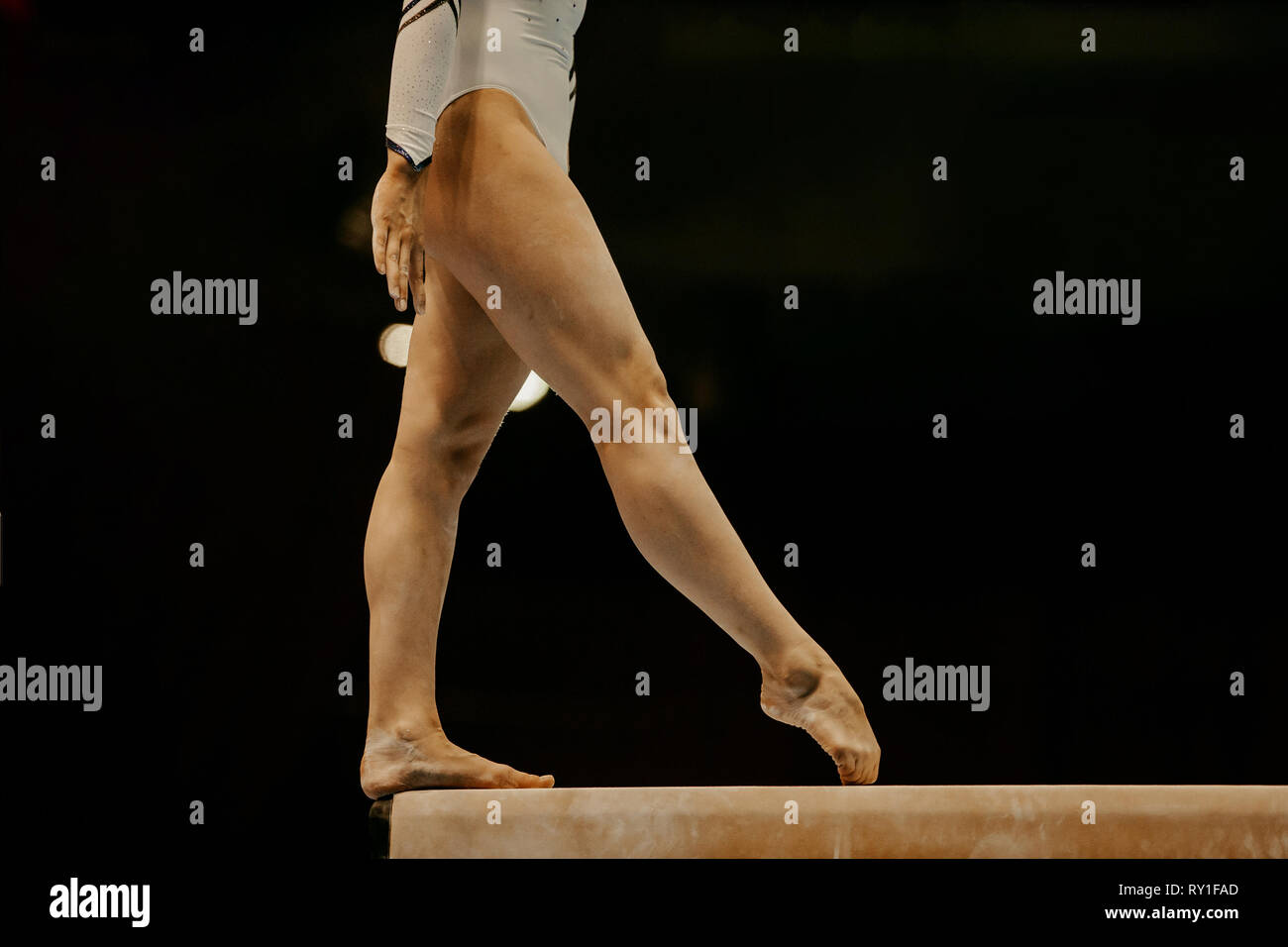 Vista laterale gambe ginnasta femmina in equilibrio la ginnastica del fascio Foto Stock